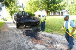 Men tarring road